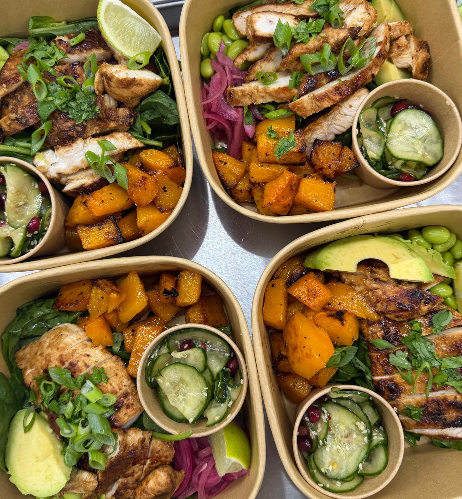 Meal prep boxes with chicken, roasted squash and avocado