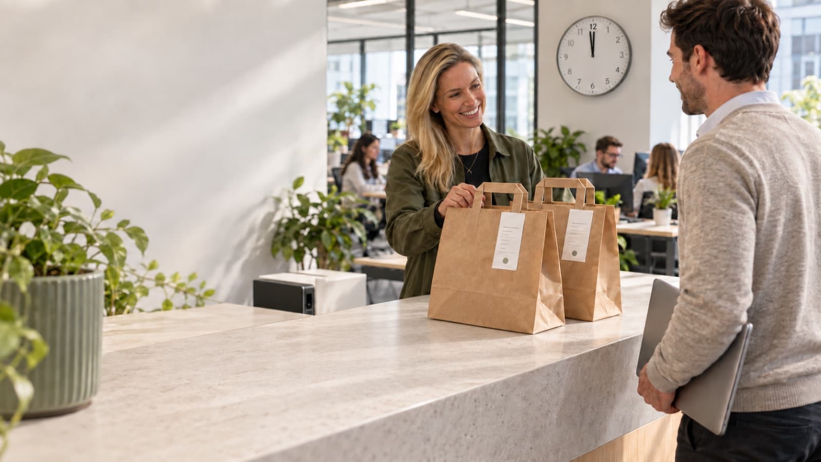 Lunch bags being handed over at an office reception desk